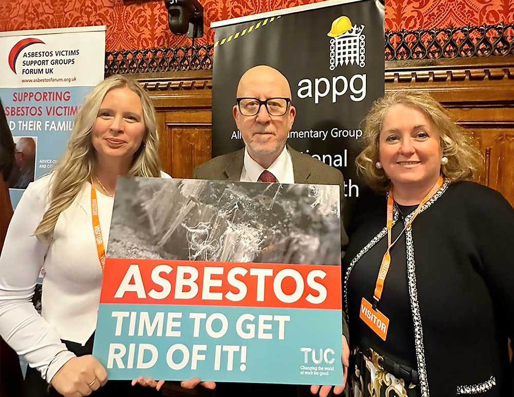 3 people holding a sign that says: Asbestos - Time to get rid if it!